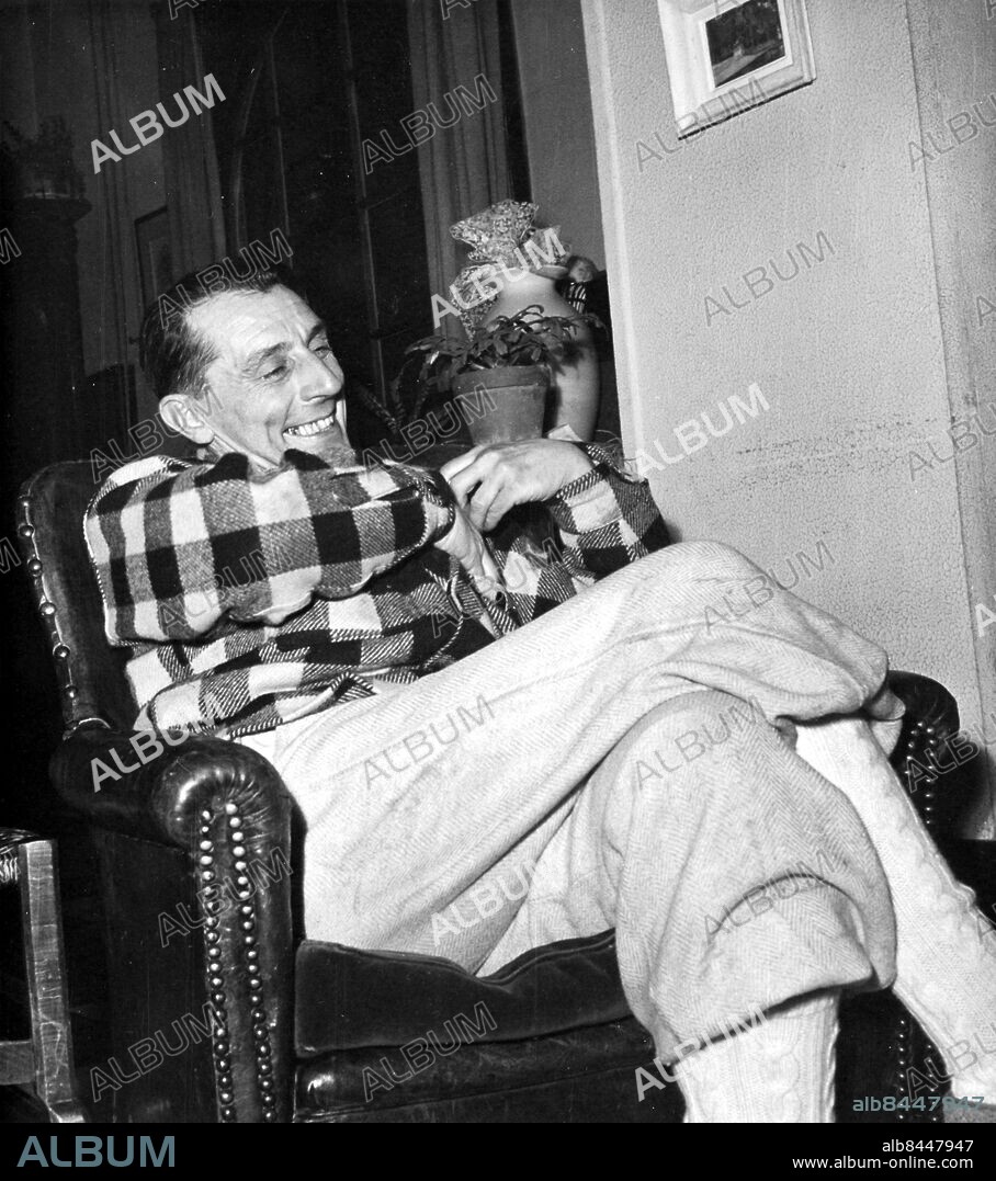 Orig.bildtext... JOLIOT-CURIE DENIES COMMUNISTS REPRIMAND. Dr. Frederic Joliot-Curie, father of Zoe,the french atomic pile, today denied in an exclusive interview with INS correspondents the story published by a french evening newspaper saying that he had been reprimanded for titism, or Nationalist deviation from the Communist party line, on account of statements made at an anglo-american press association meeting that a french communist, like any other, could not be expected to turn over secrets entrusted with him to any other nation. Photo shows Mr. Joliot-Curie interviewed by INS correspondents just as he returned from a fishing trip and read the story of his reprimand. He insisted the story of a reprimand was baseless, and reiterated his statments followed the communist line. Anm. Nobelpris i kemi 1935 tillsammans med Irène Joliot-Curie. persons: Frédéric Joliot-Curie sites: FRANKRIKE*.