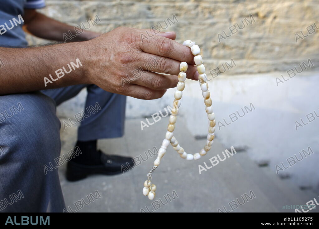 Man holding prayer beads, Baku, Azerbaijan, Central Asia, Asia.