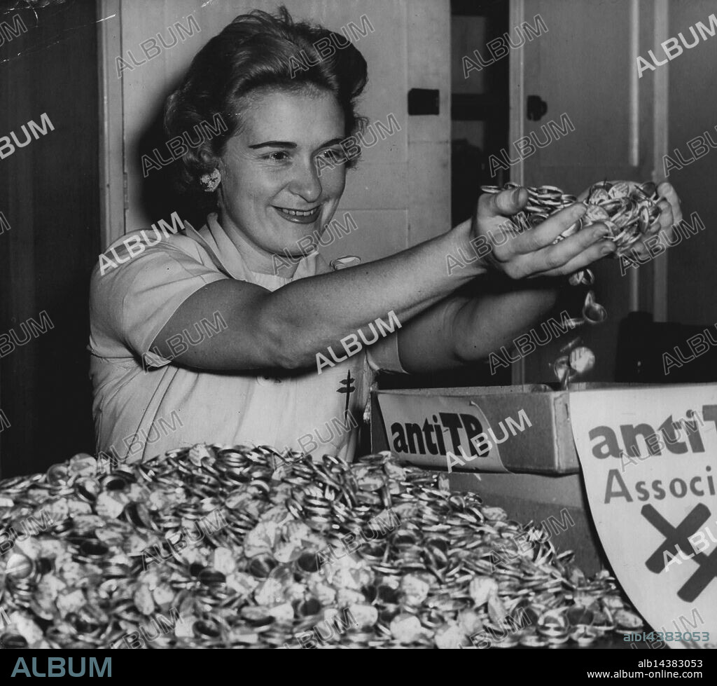 Miss June Wilson, of Petersham, sorting buttons and putting them into sellers boxesat the Anti-T.B. Assoc. Revenue Office, Surry Hills to-day. The Association are having a button day next Friday. There are nearly 10,000 badges on the table. The Assoc. Plans to sell 400,000 badges. October 04, 1955. (Photo by Ted Foster).