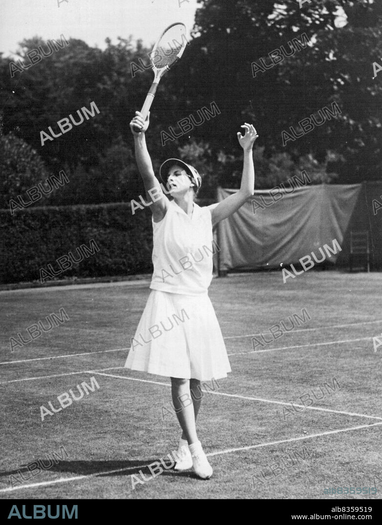 Pretty Pirouette -- A ballet dancer of the Moscow School Gould very well envy this graceful ballet pose into which Mrs. Helen Wills Moody has unconsciously fallen during her match with Virginia rice at the seabright tennis tournament. Mrs. Moody won in the astonishingly short ***** of twenty five minutes and seems intend on attaching ***** on a seabright tennis bowl, a tennis accomplished ***** has so far eluded her. In her next mach she ***** Levi of New York. July 28, 1931. (Photo by International Newsreel Photo).