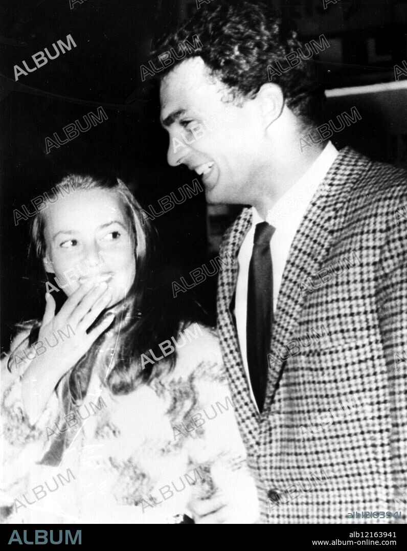 Pictured in gay mood as they walked down an Athens street are French actress Jeanne Moreau , 37 , and young Greek actor Theodore Roubanis . Miss Moreau has been seen in the 24 year old actor's company visiting Athens night spots for the past two weeks , a spokesman for the great French actress described Greek newspaper reports that she was planning to marry Roubanis as pure imagination . Miss Moreau is in Greece to film A Sailor from Gibraltar , in which Roubanis plays the role of a sailor . He is a former Greek Merchant Marine Sailor . 29 November 1965.