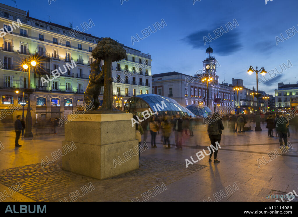 View of Bear and Strawberry Tree statue and Puerta Del Sol at dusk, Madrid, Spain, Europe.