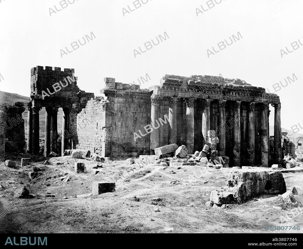 The Temple of Bacchus is one of the best preserved and grandest Roman temple ruins in the world. The temple was commissioned by Roman Emperor Antoninus Pius and built close to the courtyard in front of the larger temple of Jupiter-Baal. The period of construction is generally considered between 150 AD to 250 AD. The temple is is 216 feet long, 115 wide, and 102 feet high. Its walls are adorned by 42 un-fluted Corinthian columns, 19 of which remain upright in position standing 62 feet high. The columns support a richly carved entablature. Inside, the cella is decorated with Corinthian half-columns flanking two levels of niches on each side, containing scenes from the birth and life of Bacchus. Baalbek is a town in the Beqaa Valley of Lebanon situated east of the Litani River. After Alexander the Great conquered the Near East in 334 BC, the existing settlement was named Heliopolis. The city retained its religious function during Greco-Roman times, when the sanctuary of the Heliopolitan Jupiter-Baal was a pilgrimage site, and one of the largest sanctuaries in the empire. Starting in the last quarter of the 1st century BC (reign of Augustus) and over a period of two centuries (reign of Philip the Arab), the Romans had built a temple complex in Baalbek consisting of three temples: Jupiter, Bacchus and Venus. On a nearby hill, they built a fourth temple dedicated to Mercury. Photographed by FÃ©lix Bonfils, circa 1870-80.