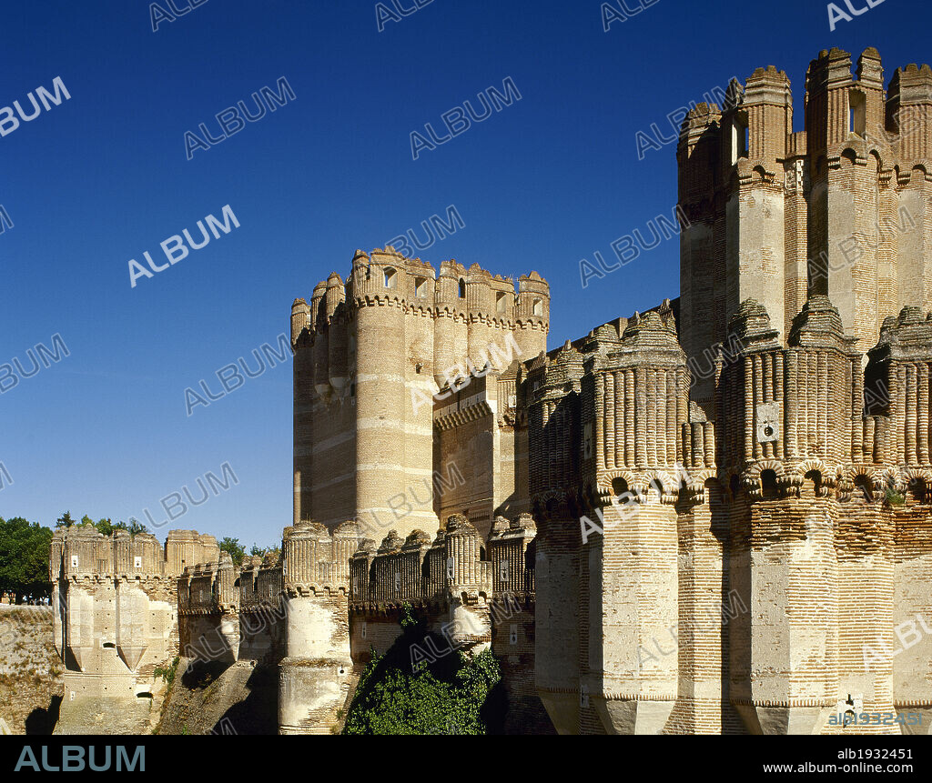 Spain, Castile and Leon, province of Segovia. Coca Castle. It was built in the late 15th century by the Castilian magnate Don Alonso de Fonseca. Mudejar style. Battlements of a tower. Exterior architectural detail.