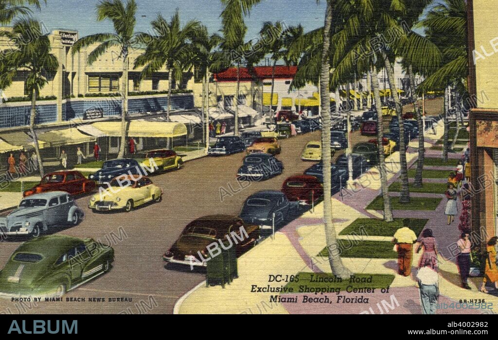'Lincoln Road, Exclusive Shopping Center of Miami Beach', Florida, USA, 1948.  Vintage linen postcard showng a view down Lincoln Road where shops line the palm tree lined street. Cars drive down the street and are parked at the kerb as shoppers stroll down the sidewalks.