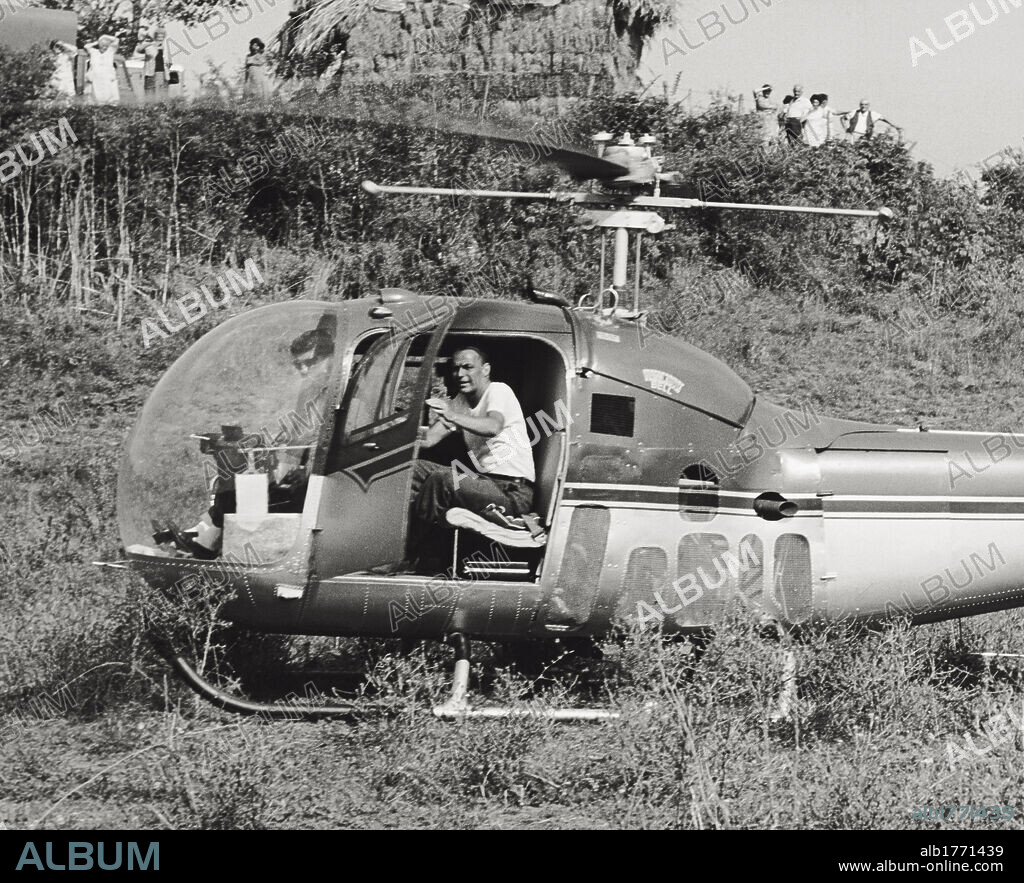 Frank Sinatra on a helicopter. The Italian-American singer and actor Frank Sinatra closing the helicopter's door on the set of 'Von Ryan's Express'. Italy, August 1964.