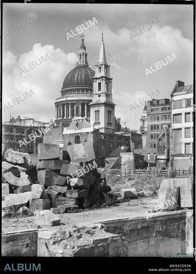 CHARLES WILLIAM PRICKETT. St Paul's Cathedral, St Paul's Churchyard, City of London, City and County of the City of London, Greater London Authority, 1941-1945. A view looking south-west across a bomb damaged landscape towards the Church of St Vedast-alias-Foster with St Paul's Cathedral beyond. The Church of St Vedast-alias-Foster was rebuilt by Christopher Wren after the Great Fire of London in 1666. In the Second World War it was gutted by fire during the Blitz in 1940-41 and was later rebuilt after the war with work starting in 1953. St Paul's Cathedral survived the bombing raids but other buildings in the area were completely destroyed by high explosives and incendiary bombs.