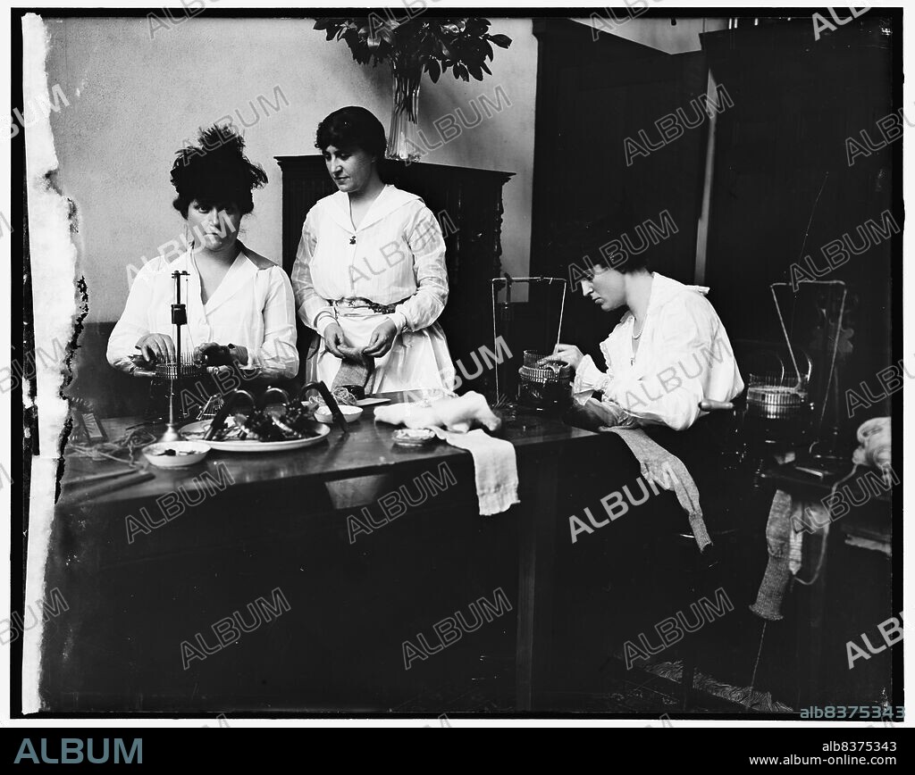 HARRIS & EWING. Miss Josephine Patton; Mrs. C.C. Marsh; Mrs. George D. Widener, between 1910 and 1920. Women using knitting machines to knit socks.