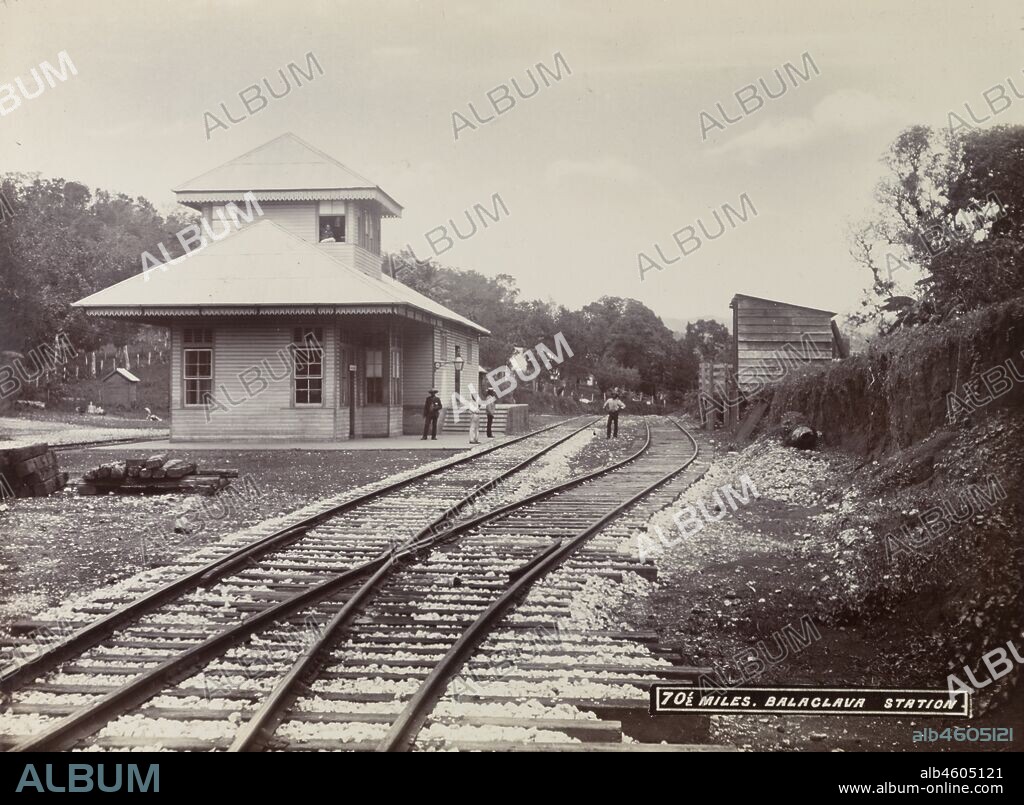 Jamaica, A group of men loiter on the platform and track outside Balaclava railway station, located on an extension line running between Porus and Montego Bay.Caption in the negative reads: 70½ miles. Balaclava Station, 1894-1895. 1999/221/1/62/3.