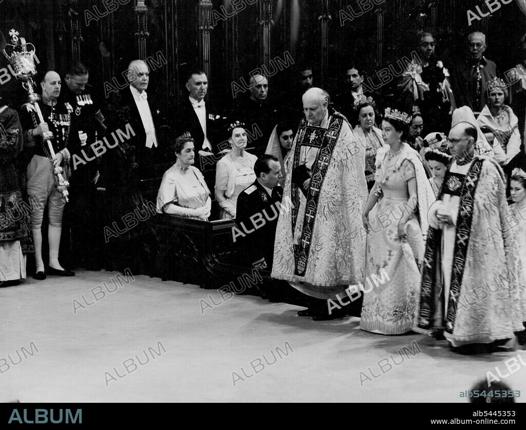 Coronation: The Queen In The Abbey The Queen during her progress through Westminster Abbey after her arrival for the Coronation ceremony to-day (Tuesday). On either side of the Queen are the Bishop of Durham, the Rt. Rev. Arthur Michael Ramsay (left) and the Bishop of Bath and Wells, the Rt. Rev. Harold William Bradfield. The Queen is wearing her Royal robe of crimson velvet, trimmed with ***** and bordered with gold lace. On her head, she has a diadem of precious stones. The Queen is also wearing the collar of the Garter. June 2, 1953. (Photo by Reuterphoto).