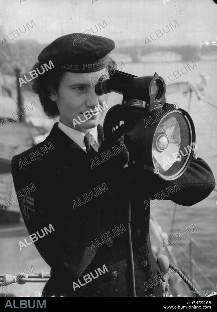 Signalling London - Signal when Valerie Lomax, 20, of Hove ***** the new Aldis Longrange signalling ***** aboard her ship HMS President to *****exchange massages with important London buildings on Thames side today Thursday.The new lamp, five times more powerful than the previous model, is designed for ease of operation and to lessen ***** for the operator. A bulb ***** at full brilliance the whole *****, with signals made by a tubular shutter, which cuts off the light. The built-in telescopic sight enables the signaller to pick up a small target and helps in reading massages flashed at extreme ranges.The new lamp, weighing 4¾ pounds, is robust, watertight, and proof against sea water coarosion. October 07, 1954. (Photo by Reuterphoto).