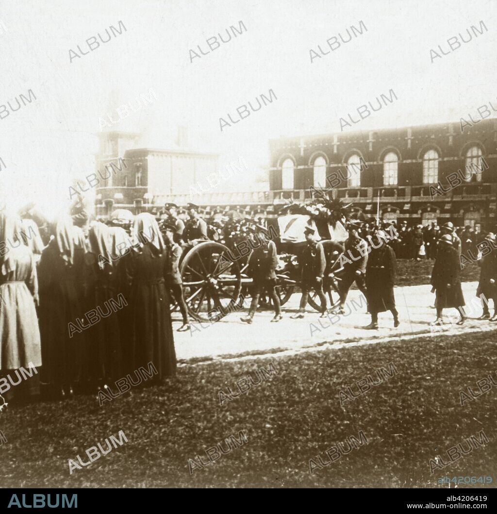 Burial of Edith Cavell, Brussels, Belgium, 1915. British nurse Edith Cavell (1865-1915) was appointed matron of the Berkendael Medical Institute, Brussels, in 1907. During the German occupation of Belgium in World War I, the Berkendael Institute was converted to a military hospital. In August 1915 Cavell was arrested by the Germans and tried and found guilty of assisting the escape of 200 Allied soldiers to neutral Holland. She was executed by a firing squad on October 12, 1915. She was buried in Brussels until after the war when her body was brought back to Britain for a memorial service at Westminster Abbey and then transferred to Norwich for re-burial. Photograph from a series of glass plate stereoview images depicting scenes from World War I (1914-1918).
