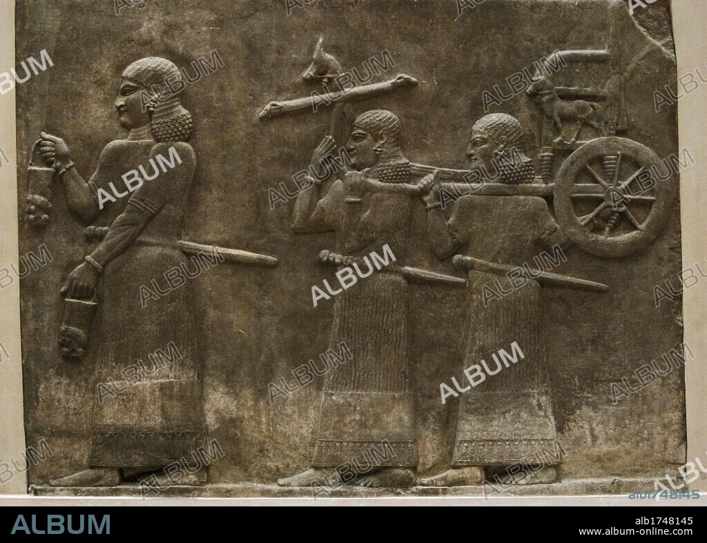 MESOPOTAMIC-ASSYRIAN ART. SERVANTS CARRYING THE SARGON CART. Relief from the PALACE OF SARGON II in Dur Sharrukin, ancient Assyria (Current Khorsabad in Iraq). 713-716 BCE (8th century BC). Louvre Museum. Paris. France.