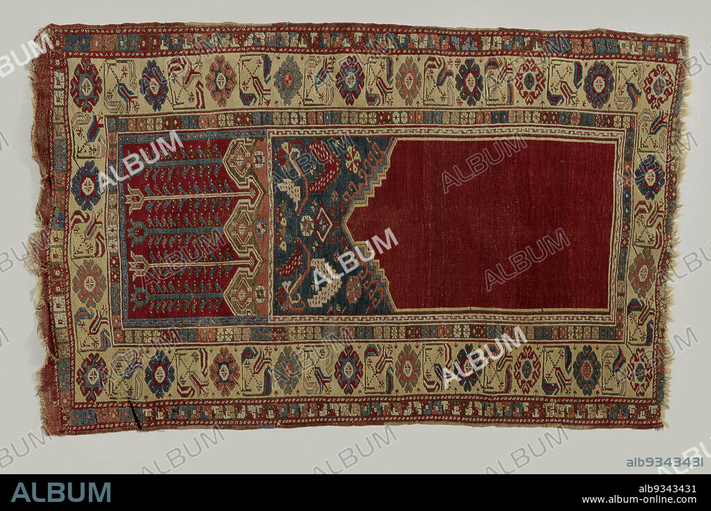 Prayer rug with upper warp panel, LADIK, Prayer rug with upper warp panel, LADIK. Center field: plain red mihrab with a stepped gable top raised in the center. Blue swags with multicolored star flowers and toothed lancet leaves on a reclining S-rank. A crenellated border is in pink with white omega line, intervening in a red upper panel, on which are long tulips, alternating in blue (3) and white (2). Edges: quadruple. The main border is soft yellow with diamond-shaped, printed rosette flowers, alternating with angled, striped tulips. An inner hem is black with multicolored rosettes. The outer border is also black, with carnations. A white frame runs around the niche and swags; another frame runs around the top panel on three sides. Beard: a plain red beard 5 cm. wide is (still ddels) present at the top., Ladik, 1800 - 1900, wool, height 179 cm × width 109 cm.