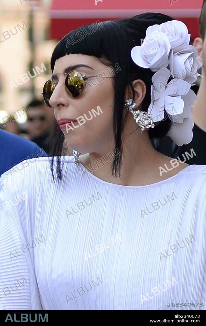 June 20, 2014 - New York, New York, U.S. - Singer LADY GAGA seen wearing a white flowing puffy dress sporting black hair takes a stroll in Central Park South followed by fans. 20/06/2014