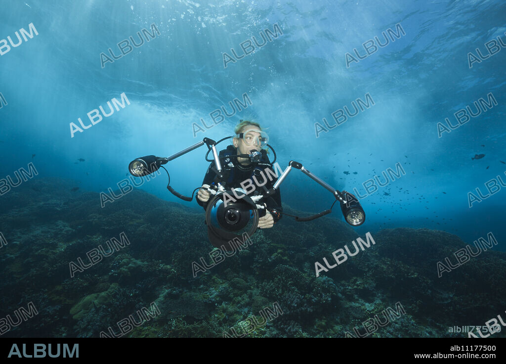 Scuba diver in surf zone, Christmas Island, Australia.