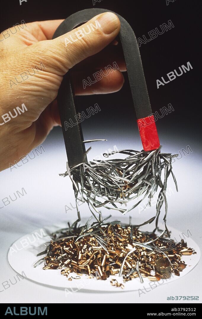 Magnet picking up iron filings from a plate of copper and iron. Iron is ferromagnetic. This means that when iron filings are brought close to a magnet the individual filings will become tiny magnets themselves.