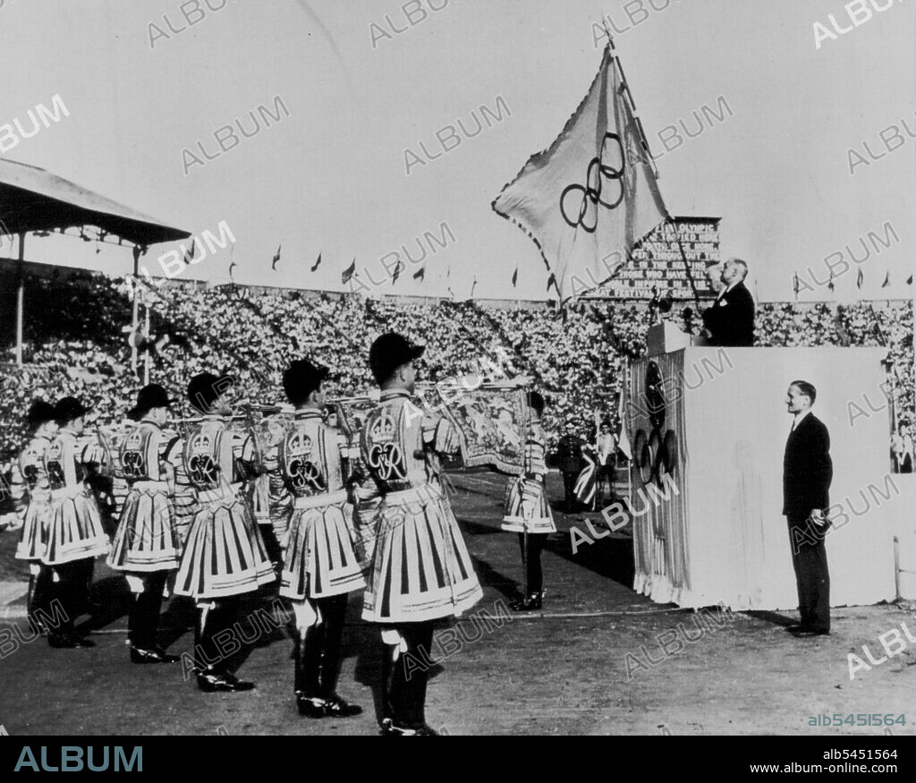 The XIV Olympiad Closed -- Sir Frederick Wells, lord mayor of London, holds the Olympic flag as the state trumpeters blare the official end of the fourteenth modern Olympic games is Wembley Stadium in London Saturday. At Well's right is J. Sigfrid Edstrom, President of the International Olympic committee. Right foreground is Lord Burghley Chairman of the Olympic organizing committee. August 16, 1948. (Photo by AP Wirephoto).