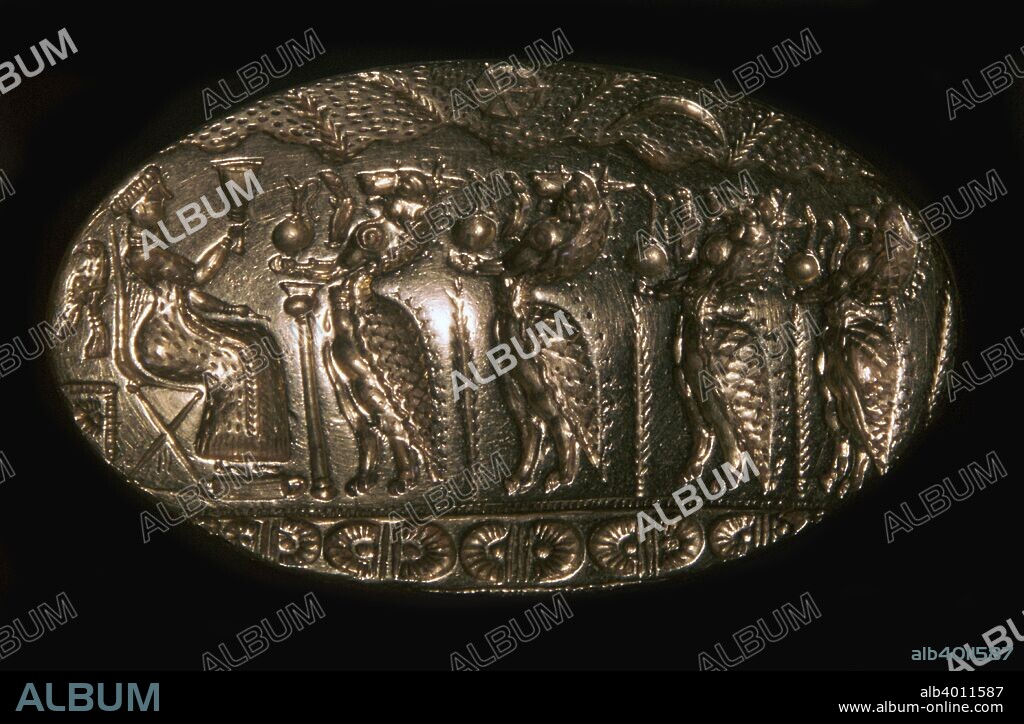 Mycenaean gold signet ring from Tiryns, picturing a fertility rite. A lion headed genii hold libations in front of a goddess who holds a stemmed chalice. From the National Museum's collection in Athens, 13th century BC.