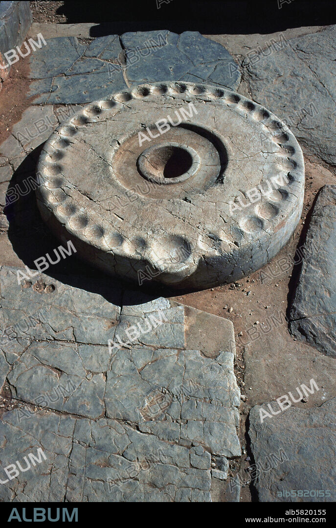 Sacrificial stone (kernos) of the Palace of Mallia, Crete. The kernos has 34 cavities for offering various seeds.