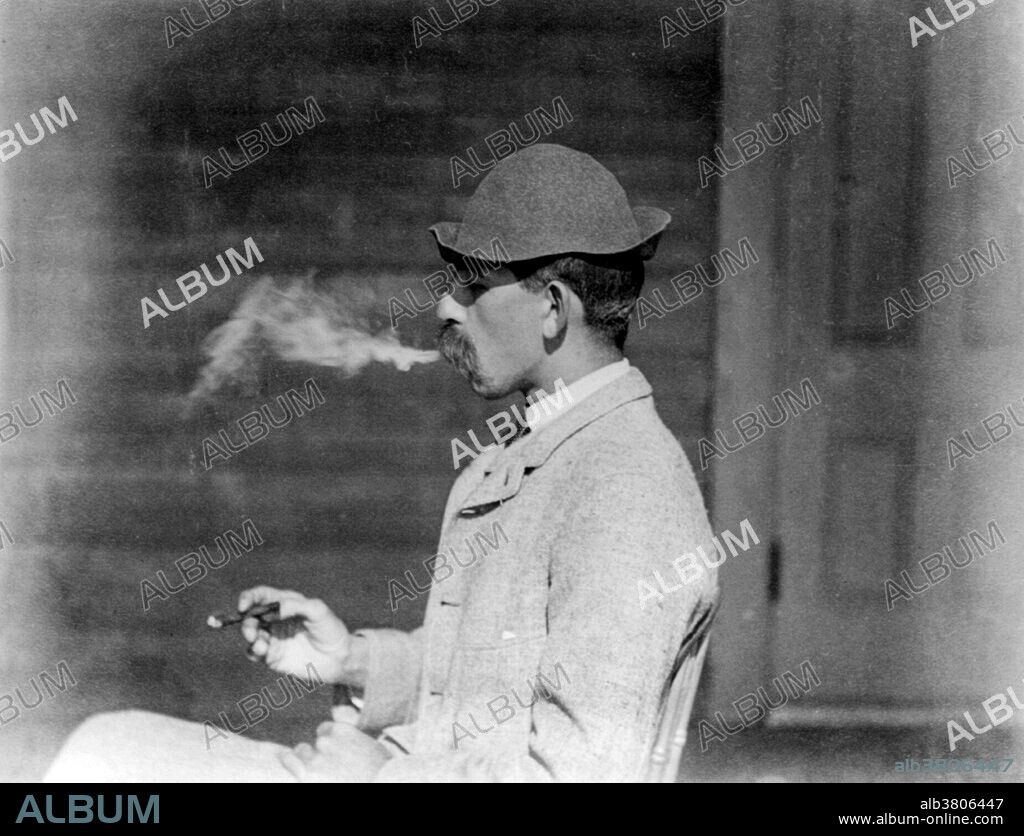 Entitled: "A whiff of comfort" shows a man smoking a cigar. Kineo House, Moosehead Lake, Maine. A cigar is a tightly-rolled bundle of dried and fermented leaf tobacco which is rolled in a series of types and sizes that is ignited so that its smoke may be drawn into the mouth. In the 19th century, cigar smoking was common, while cigarettes were still comparatively rare. Photographed by Joseph John Kirkbride, 1890.