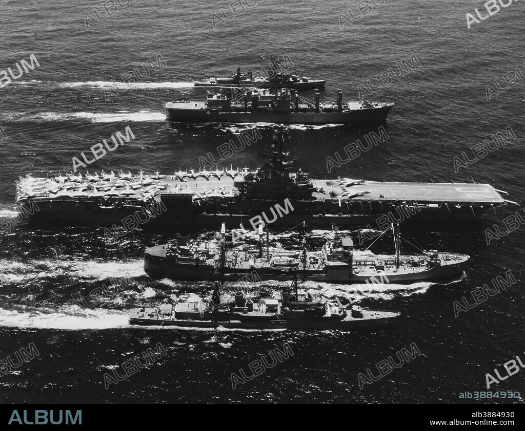May 1969 - U.S. Navy Seventh Fleet ships replenishing in the South China Sea. Ships present are (from front to back): USS Wiltsie (DD-716); USS Tappahannock (AO-43); USS Oriskany (CVA-34); USS Mars (AFS-1); and USS Perkins (DD-877);.