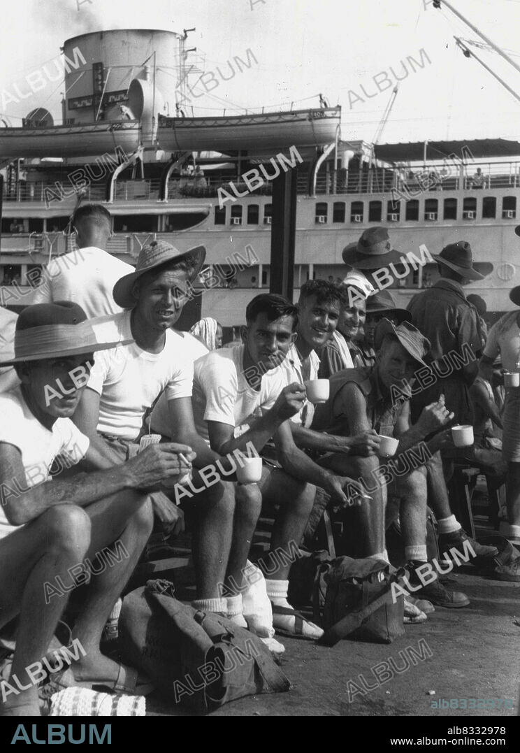 Prisoners of war released from Changi Prison Camp were evacuated from Singapore by the Australian Hospital Ship Manunda, the first Australian ship to arrive at Singapore after the surrender of the Japanene. Shown, a group of 8 Division. September 13, 1945. (Photo by Australian War Memorial Canberra).