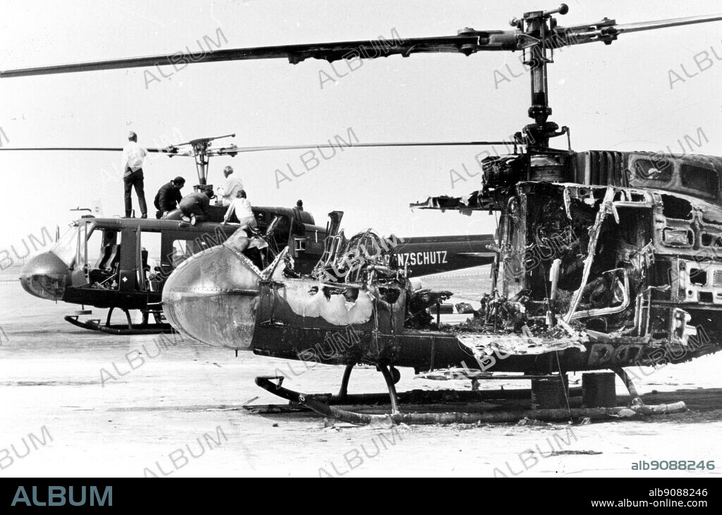 Incident at the Munich Olympics, 1972. Helicopter wreckage. Experts examine the wreckage of two German Border Police helicopters at Fuerstenfeldbrueck, near Munich. The helicopter in the foreground is burnt out after a hand grenade explosion. Nine Israeli Olympic athletes dies in a shoot out between their Palestinian captors and German Police.