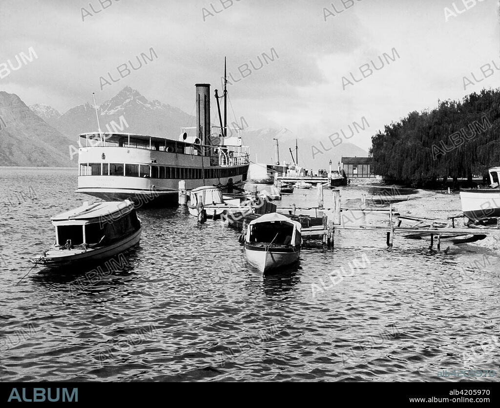 Magic lantern slide circa 1900.Victorian/Edwardian social history. The TSS Earnslaw is a 1912 Edwardian vintage twin screw steamer plying the waters of Lake Wakatipu in New Zealand. It is one of the oldest tourist attractions in Central Otago, and the only remaining commercial passenger-carrying coal-fired steamship in the southern hemisphere. The ship was named after Mount Earnslaw, a 2889-metre peak at the head of Lake Wakatipu. The keel was laid on 4 July 1911. Pictured at Queenstown warf.