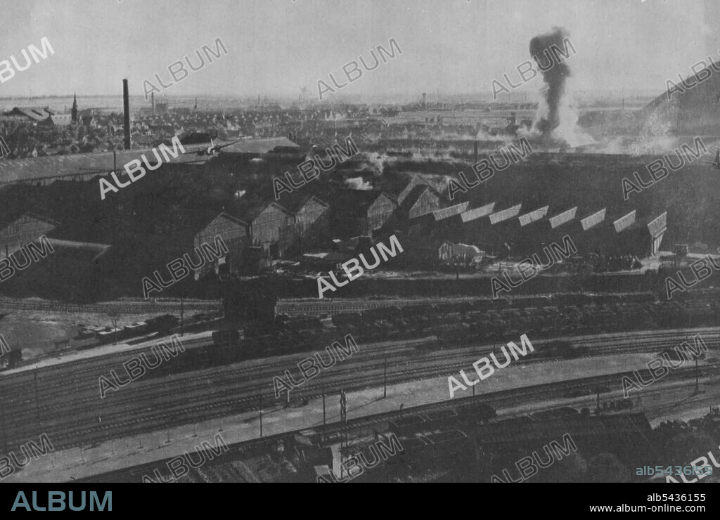 R.A.F. Bostons Attack Steel Works At Denain, France. Two Bostons (left and right) sweeping low over their target whilst a plume of smoke rises from a bomb burst behind them. This photograph, taken during an attack by Bostons of R.A.F. Fighter Command on 16.8.43., provides remarkable evidence of the precision with which the important steel and armament works of the Soc. Francaise de. Constructions Mecaniques, and of the S.A. Des Hauts Fourneaux Forges at Acieres de Denain at D'Anzin, were hit by.