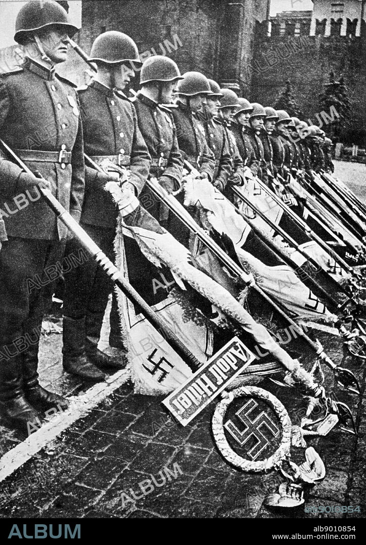 Nazi banners and symbols are gathered to be publicly burned in Red Square Moscow. 1945.