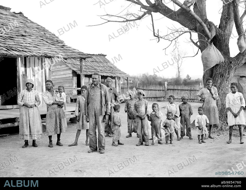 Group of descendants of former slaves of the Pettway Plantation, living under primitive conditions on the plantation, Gees Bend, Alabama, USA, Arthur Rothstein, U.S. Farm Security Administration, February 1937.