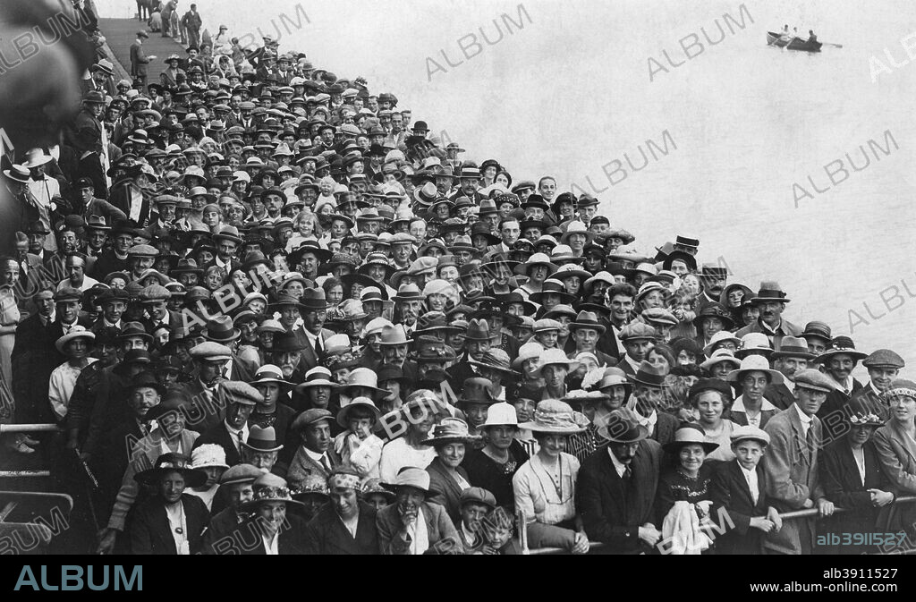 People waiting to go on a boat trip, Bournemouth Pier, August 1921.