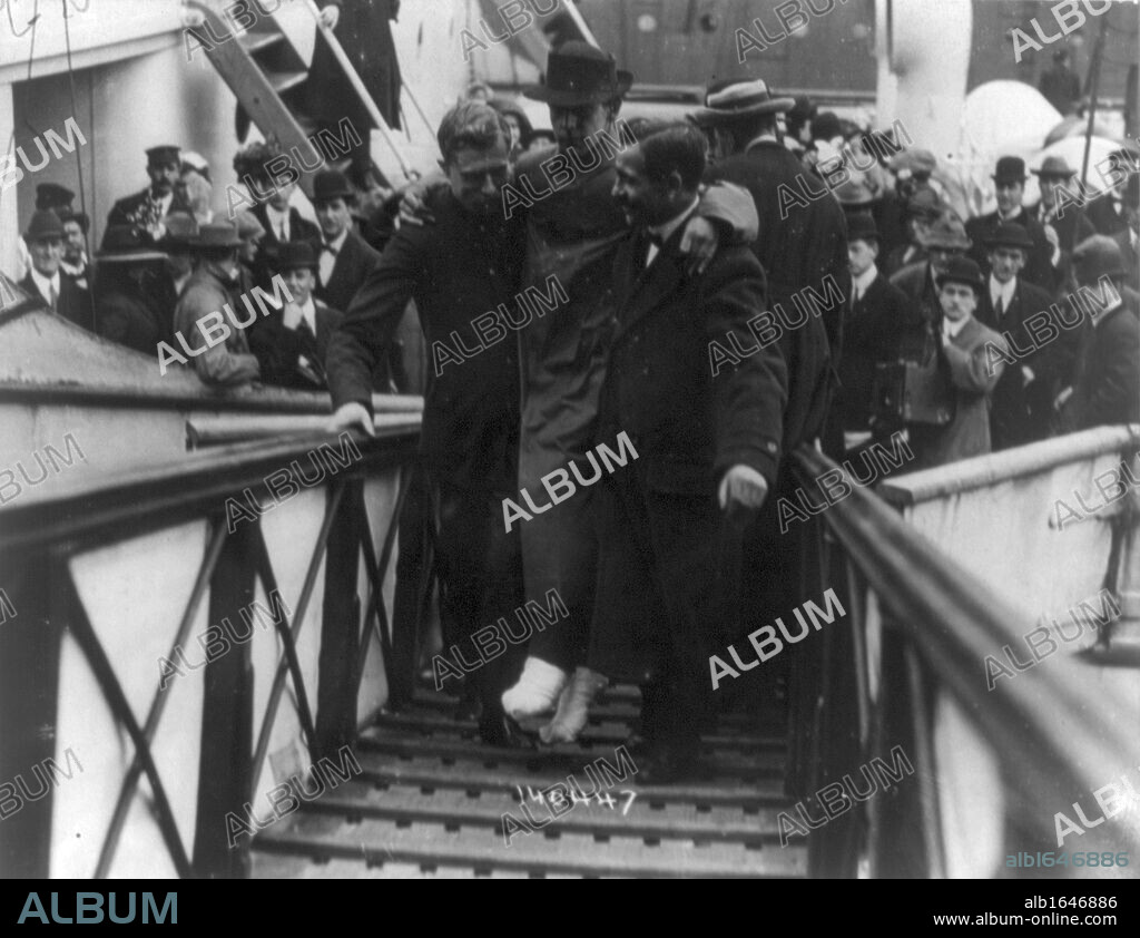 Loss of White Star Line's Olympic-class vessel RMS Titanic which struck an iceberg on 12 April 1912 on her maiden voyage. Surviving wireless operator, Harold Bride, feet bandaged, being carried up gangway, New York. Disaster.