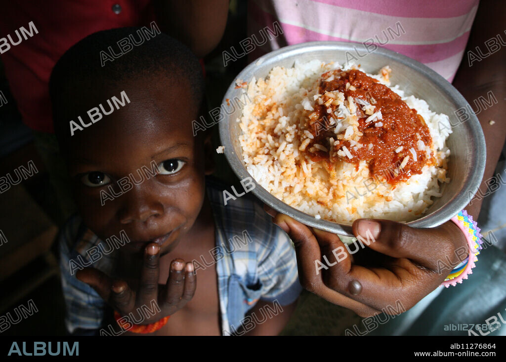 Children eating an African meal, Lome, Togo, West Africa, Africa.