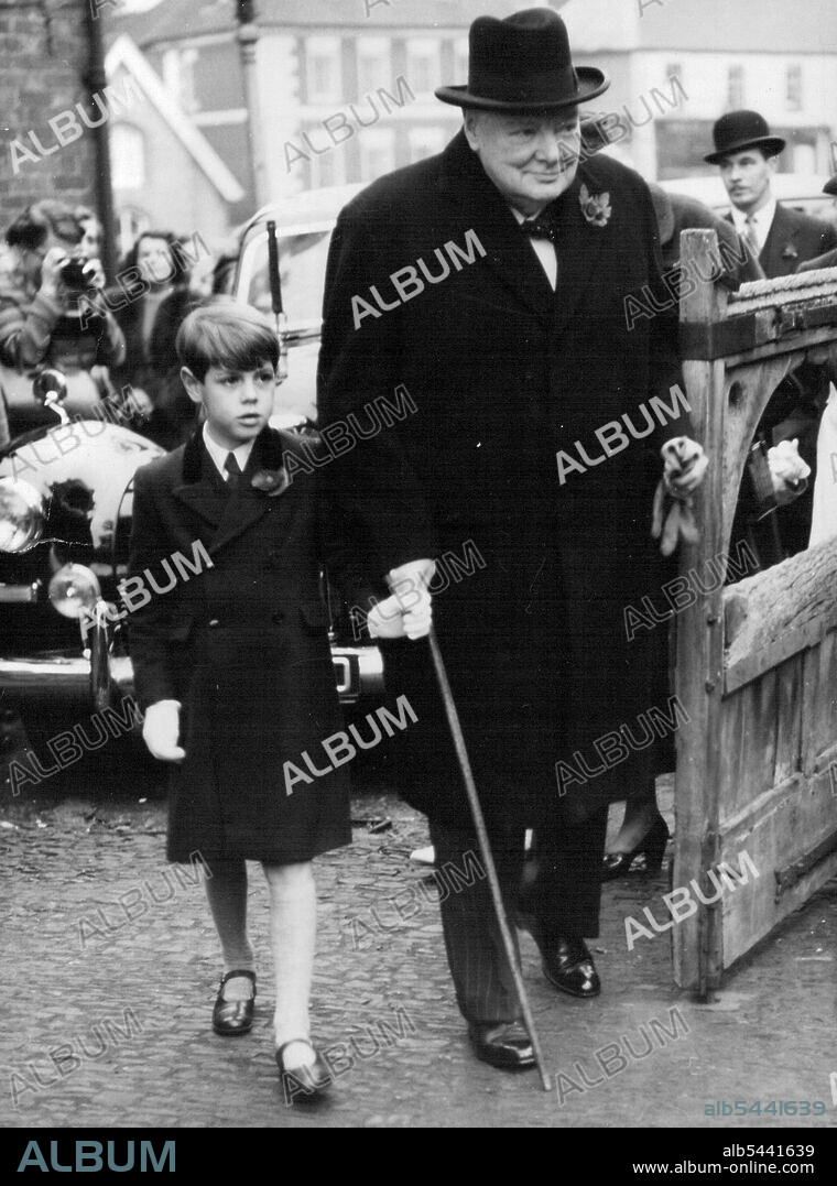Sir Winston At Grand-Daughter's Christening. Young Nicholas Soames Clutches grandfather's finger as he arrives at Westerham Parish church today with Sir Winston Churchill.. The Prime Minister, Sir Winston Churchill attended the Christening of his youngest grandchild at Westerham Parish church today. The baby is the daughter of captain Christopher Soames, M.P. and Mrs. Soames (formerly Mary Churchill) and was Christened Charlotte Clement. November 6, 1954. (Photo by Paul Popper Ltd.).