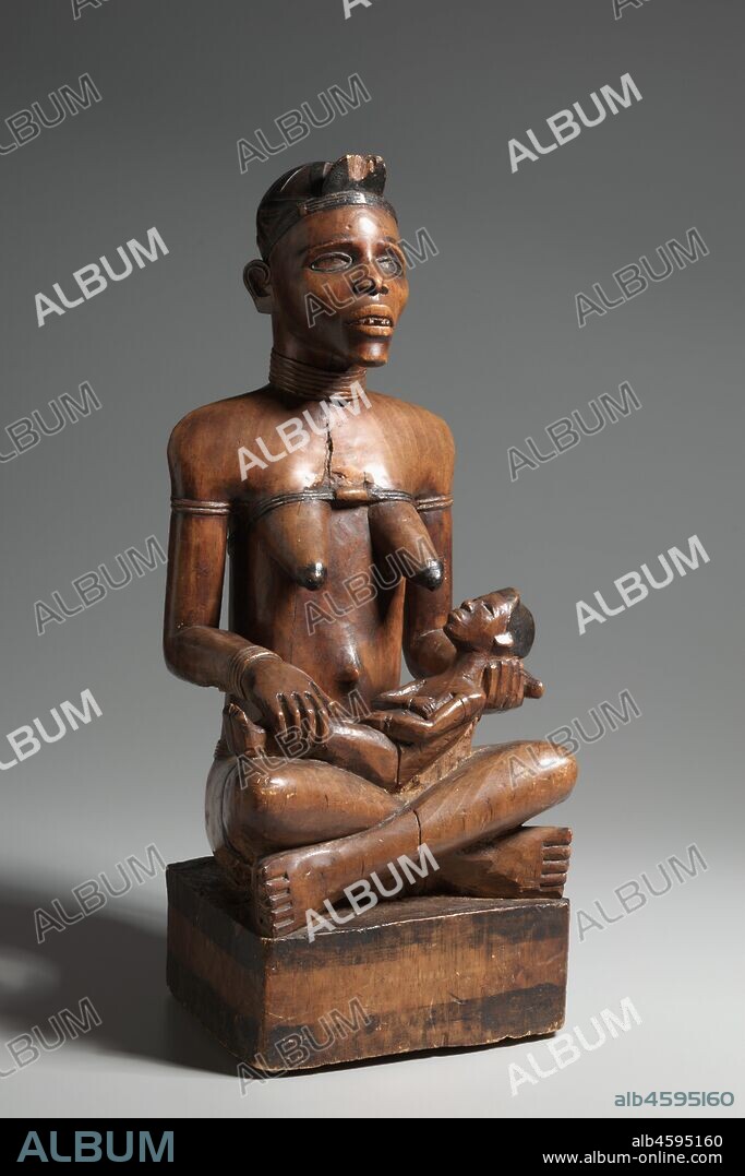 Mother and Child Figure, late 1800s-early 1900s. The Kongo people inhabit a large territory now divided among the nations of Congo, Democratic Republic of Congo, Cabinda, and Angola. The mother and child theme is common in the carving of the Yombe, one of the many Kongo ethnic groups; this example is distinguished by the emotionally powerful expression of the mother's gaunt face. The large size and soft wood of this sculpture indicate a funerary function and placement within a roofed ancestral shrine. The Yombe woman represented was clearly powerful; perhaps her fertility was critical to the survival and prosperity of her clan.