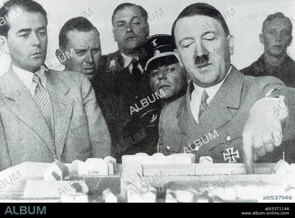 Adolf Hitler discusses a model of a building with Prof. Albert Speer, historical photo circa 1936