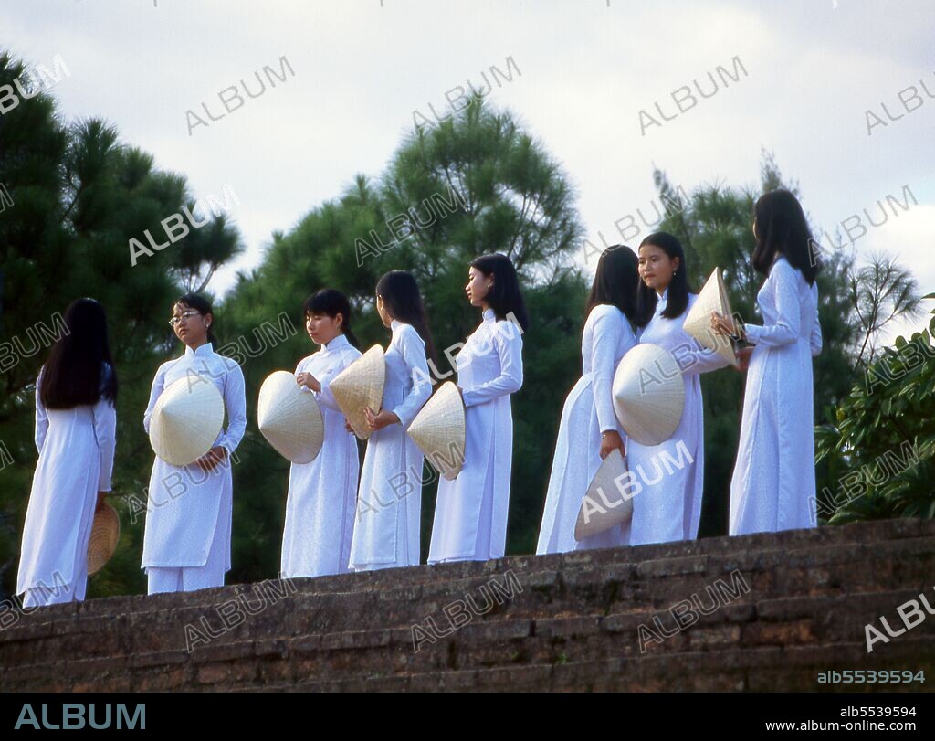 The ao dai (Vietnamese: áo dài) is a Vietnamese national costume, now most commonly for women. In its current form, it is a tight-fitting silk tunic worn over pantaloons. The word is pronounced ow-zye in the north and ow-yai in the south, and translates as 'long dress'. The name áo dài was originally applied to the dress worn at the court of the Nguy?n Lords at Hu? in the 18th century. This outfit evolved into the áo ngu thân, a five-paneled aristocratic gown worn in the 19th and early 20th centuries. Inspired by Paris fashions, Nguy?n Cát Tu?ng and other artists associated with Hanoi University redesigned the ngu thân as a modern dress in the 1920s and 1930s.