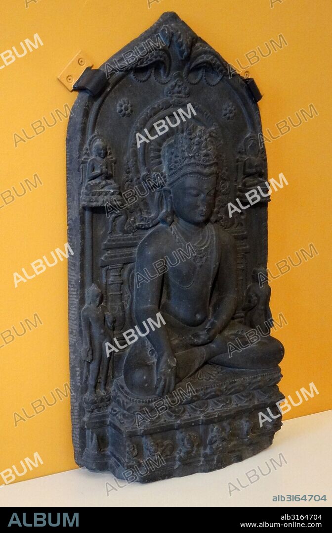 Sculpture depciting a Crowned Seated Buddha from the Pala period. Bihar, India. Dated 11th Century.