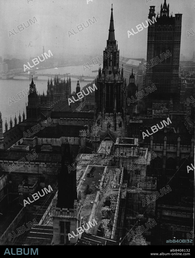 Looking Down On A Rising "House" - Among the spires and towers of Westminster (London) rises the new House of Commons, seen here In a picture taken from the Big Ben clock tower.The new building replaces the chamber which was destroyed by German air raiders in World War II. It is expected to be completed by next May.The present Houses of Parliament stand on the site of the old Palace of Westminster, named in the reign of Edward the Confessor and occupied by his successors down to Henry VIII.The "Houses" are still nominally a Royal palace, and bear the name "Palace of Westminster" as an alternative title.Style of the buildings, which were completed in the early 19th century,, is late-Gothic. September 23, 1949.