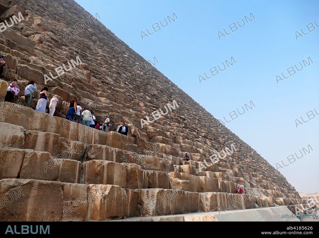 Tourist climb to enter the Great Pyramid of Giza (Pyramid of Khufu or Pyramid of Cheops). oldest and largest of the three pyramids in the Giza pyramid complex in Egypt. It is the oldest of the Seven Wonders of the Ancient World. and the only one to remain largely intact. Completed around 2560 BC.
