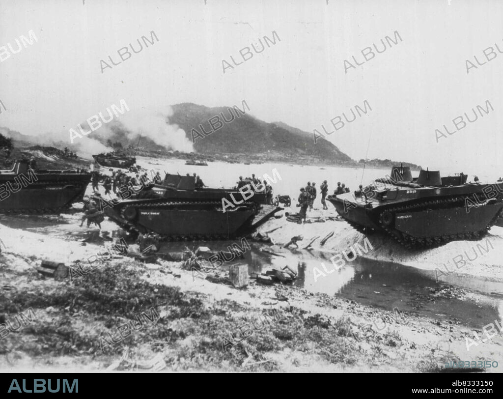 Marines On Beach At Ihiya: Marines park their amtracs ***** go about their business after landing without opposition on a beach of Ihiya Island, 15 miles northwest of Okinawa on June 3. These men are from the eighth regimental combat team. The marine corps released this picture in Washington July 16. July 16, 1945. (Photo by AP Wirephoto).
