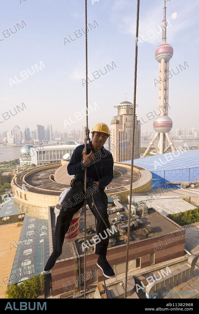 Window cleaning Shanghai style among the modern skyscrapers and new construction in the Lujiazui financial district of Pudong, Shanghai, China, Asia.