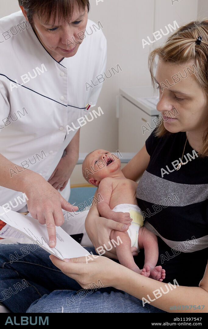 Childcare assistant explaining the health book to the mother. Saint Vincent de Paul Hospital, Lille.