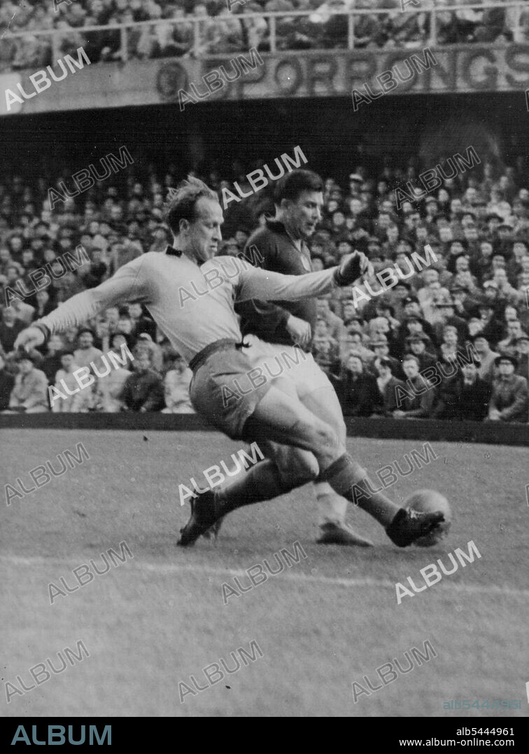 Photo Shows: Sweden's Lennart Samuelsson Tries to take the ball from the Hungarian star Puskas (Dark Shirt). Hungarians Beat Sweden The Visiting Hungarian foot ballers Defeated Sweden 7-3 at the Rasunda, Stockholm, on Wednesday. The Hungarian Soccer team, which will tour Australia this year, had a convincing 7-3 win over Sweden at Stockholm recently. Picture from the game shows Swede Lennart Samuelsson trying to gain possession from Hungarian star Ferenc Puskas (dark shirt). May 13, 1955. (Photo by Paul Popper Photo).