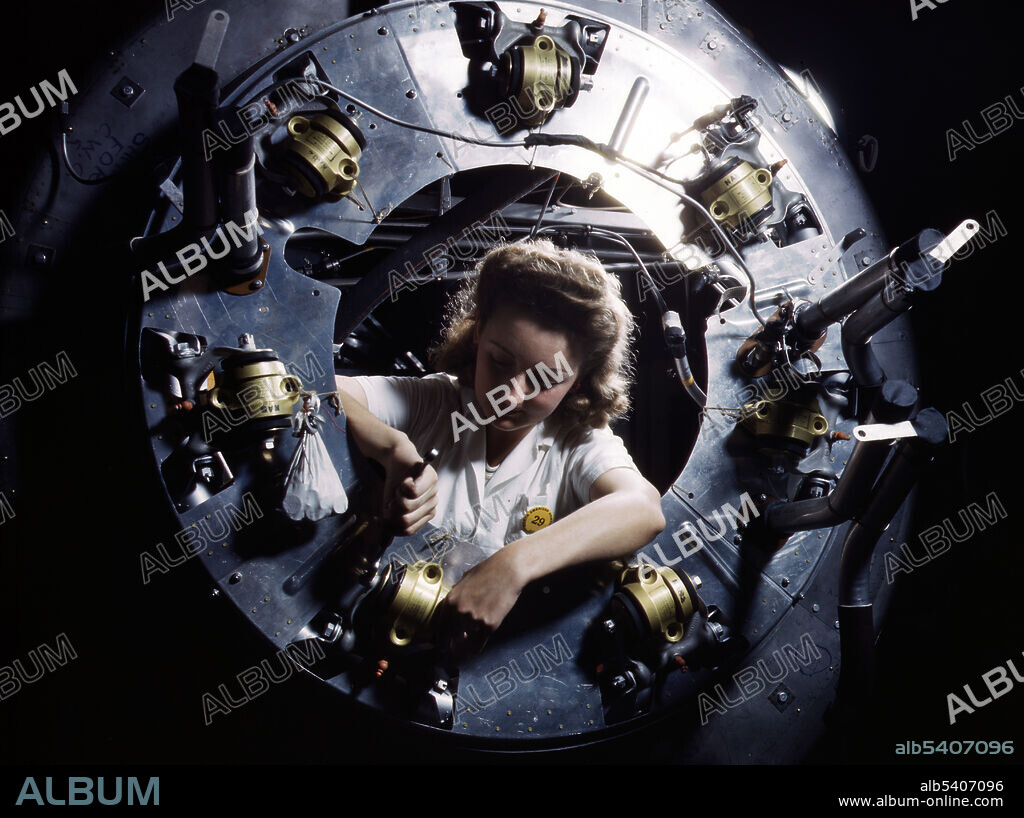 Editorial use only . Part of the cowling for one of the motors for a B-25 bomber is assembled in the engine department of North American Aviation, Inc. Inglewood, California, plant. Although the image of Rosie the Riveter reflected the industrial work of welders and riveters, the majority of working women filled non-factory positions in every sector of the economy. What unified the experiences of these women was that they proved to themselves, and the country, that they could do a man's job and could do it well. Photographed by Alfred T. Palmer, 1942.