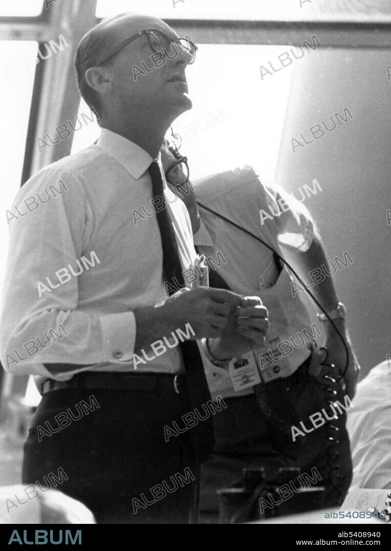 George Mueller follows the progress of the Apollo 11 mission.  George Edwin Mueller (July 16, 1918 - October 12, 2015), was an American electrical engineer who headed the Office of Manned Space Flight from September 1963 until December 1969. During the fall of 1963 Webb worked with Associate Administrator Robert Seamans to restructure NASA, shifting three key centers (Manned Spacecraft Center (MSC), Marshall Space Flight Center (MSFC), and the Launch Operations Center (LOC)) to report directly to Mueller, as well as a local staff at Headquarters. Mueller accepted the job, and took a substantial pay cut. The reorganization of NASA and the Office of Manned Space Flight (OMSF) was announced in November 1963. Hailed as one of NASA's most brilliant and fearless managers, he was instrumental in introducing the all-up testing philosophy for the Saturn V launch vehicle, which ensured the success of the Apollo program in landing a man on the Moon and returning him safely to the Earth by the end of 1969. Almost everyone who worked with Mueller on Apollo agreed he was technically brilliant and exceedingly capable. Mueller also played a key part in the design of Skylab, and championed the space shuttle's development, which earned him the nickname, the father of the space shuttle. Mueller died of congestive heart failure in 2015 at the age of 97. This photo was taken on July 16, 1969 in the Launch Control Center at the Spaceport on the morning of the launch.