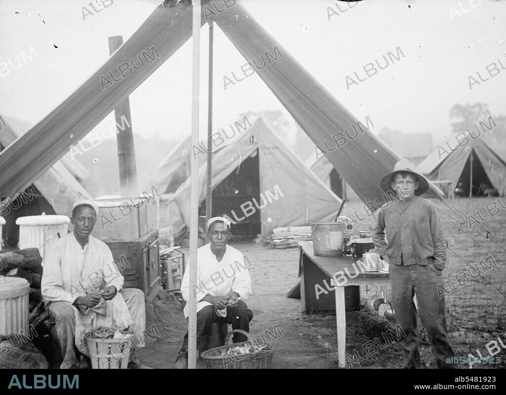 U.S. Army cook tent, peeling potatoes ca. between 1909 and 1940.