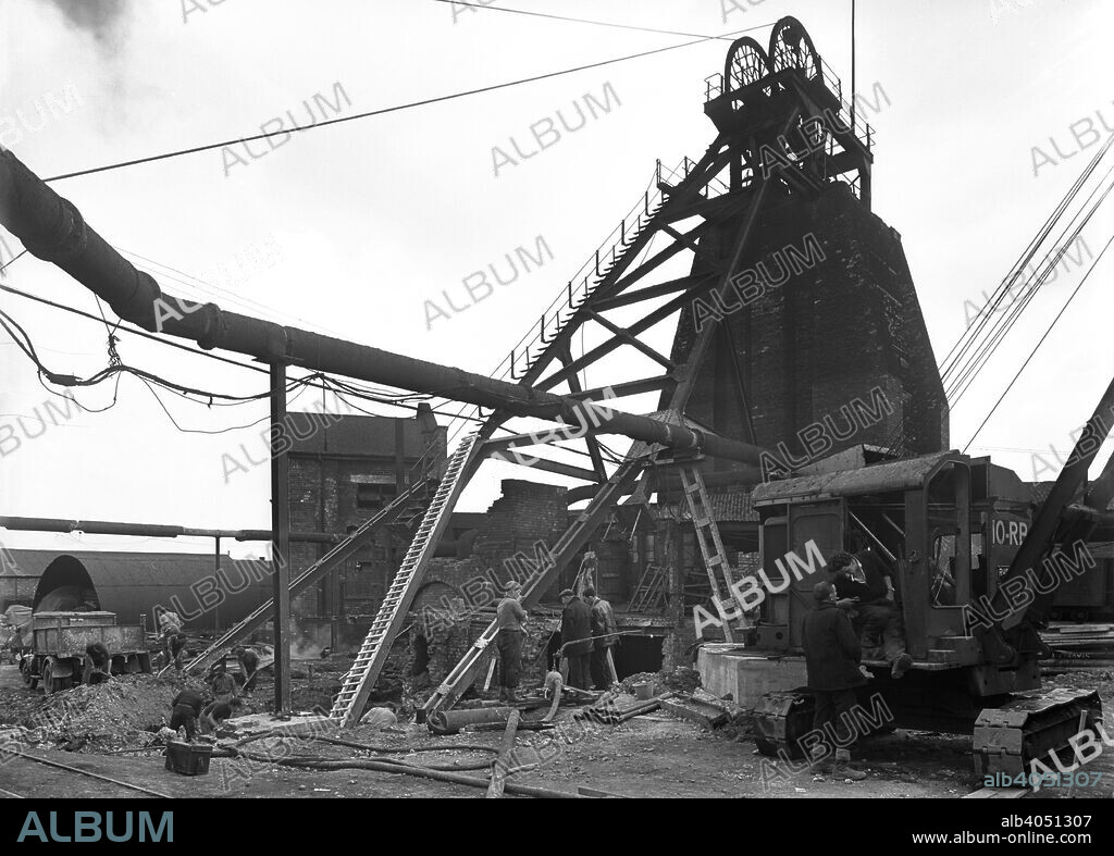 Markham Main Colliery, Doncaster, South Yorkshire, 1956. This photograph shows the upcast ascent gear at Markham main colliery in Armthorpe, near Doncaster, during refurbishment work in 1956. During the Miners' Strike in the early 1980s, there were violent clashes between strikers and police and the 'Battle of Markham Main' is a reminder of more unsettled times. The site became home to a smart new housing development after the pit closed in 1996.